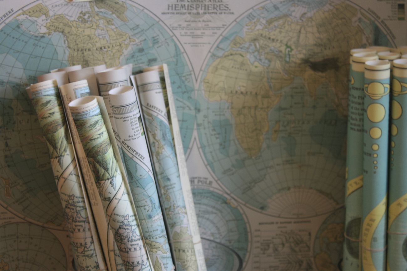 Rolled maps standing against a world